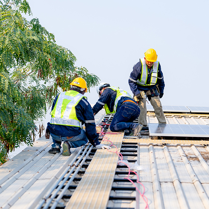 workers installing solar panels, for efficient energy on rooftop